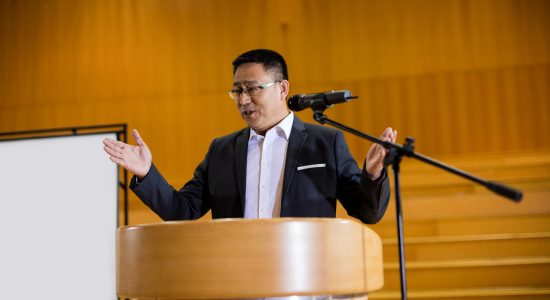 Male business executive giving a speech at conference center